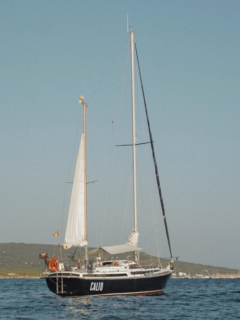 The Caliu (name of the sailboat of iATU BOATS) it's anchored at migjorn area in Formentera. Caliu it's a ketch oceanic sailboat and in the picture has the mizzen sail rised Caliu anchored at migjorn area in Formentera